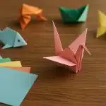 Colorful origami paper cranes and animals arranged on a table, showcasing creative folding designs