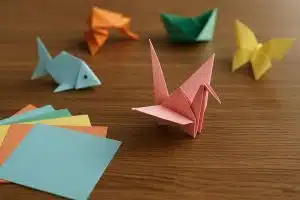 Colorful origami paper cranes and animals arranged on a table, showcasing creative folding designs