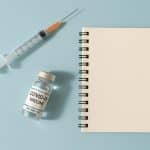 Vaccine discussion concept with medical vials and syringes representing public health debate