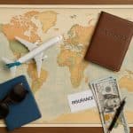 Travel insurance policy documents, passport, and map prepared for an international trip