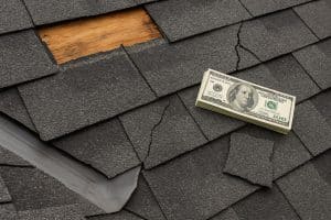 Damaged residential roof with missing shingles highlighting expensive homeowner repair mistakes