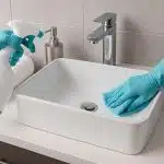 Modern bathroom with sparkling clean tiles and innovative cleaning products on countertop