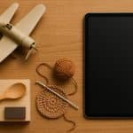 Colorful craft supplies and woodworking tools representing hands-on hobbies amidst digital devices
