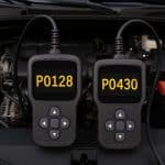 Car dashboard check engine light with highlighted P0128 and P0430 error codes diagnostic display