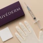 Juvederm filler syringe and cosmetic consultation tools on clinic table before treatment session