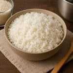 Steaming pot of fluffy white rice on a kitchen countertop for a homemade cooking guide