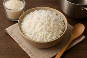 Steaming pot of fluffy white rice on a kitchen countertop for a homemade cooking guide